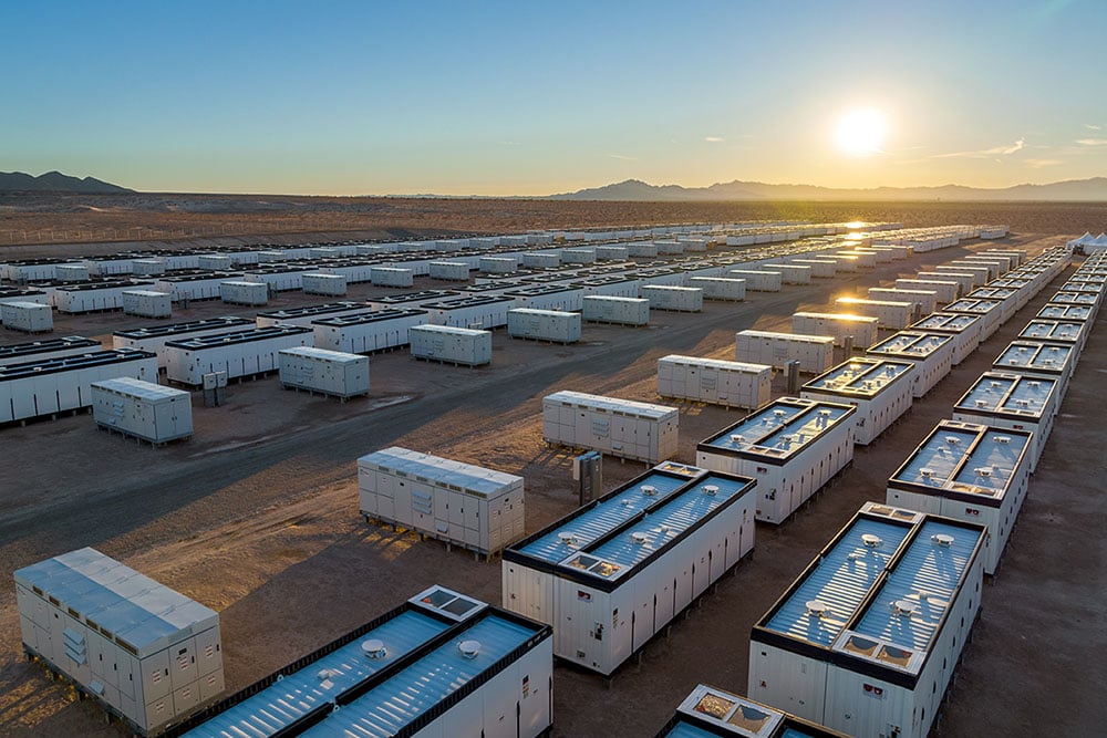 battery storage site with the sun in the distance